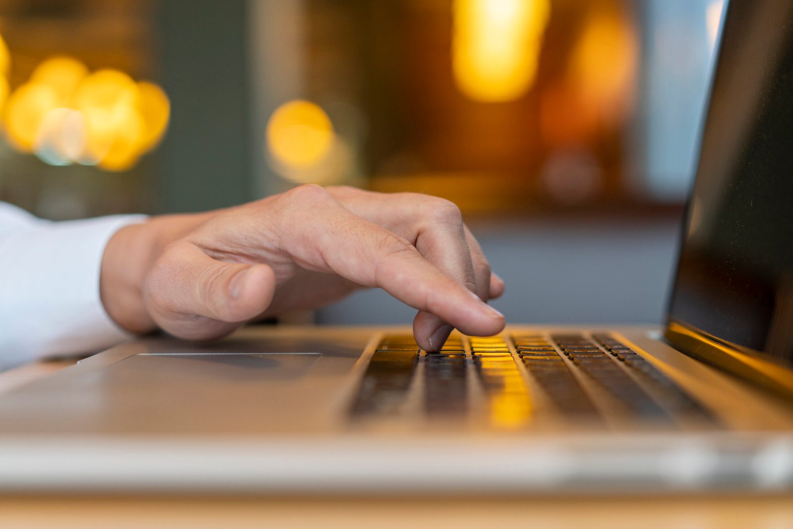 man typing laptop with bokeh scaled - AWL Metaverse Pvt. Ltd.